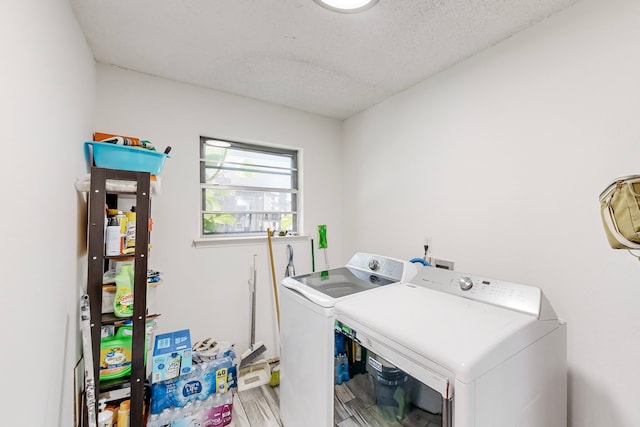 washroom with independent washer and dryer, a textured ceiling, and hardwood / wood-style flooring