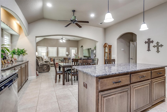 kitchen with light tile patterned floors, light stone countertops, stainless steel dishwasher, vaulted ceiling, and ceiling fan