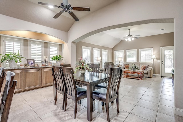 dining area with ceiling fan, lofted ceiling, and light tile patterned floors