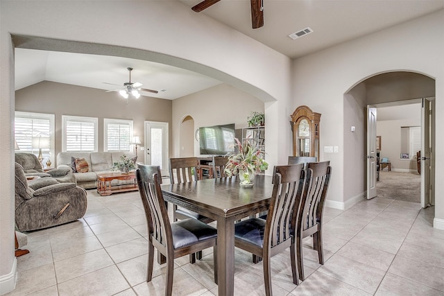 tiled dining area featuring ceiling fan and lofted ceiling