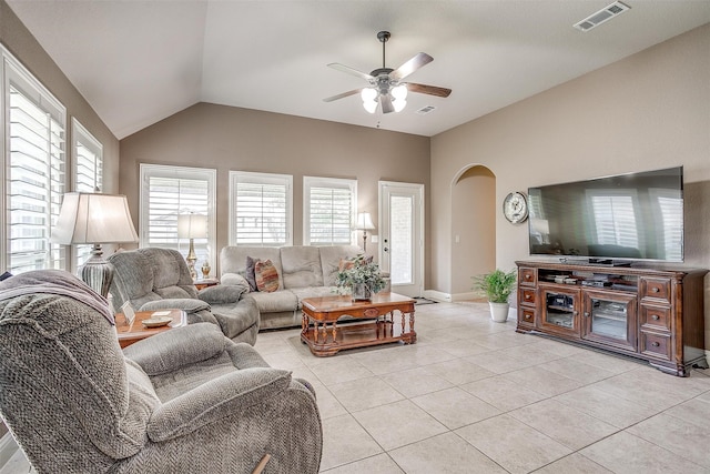 tiled living room featuring ceiling fan and vaulted ceiling