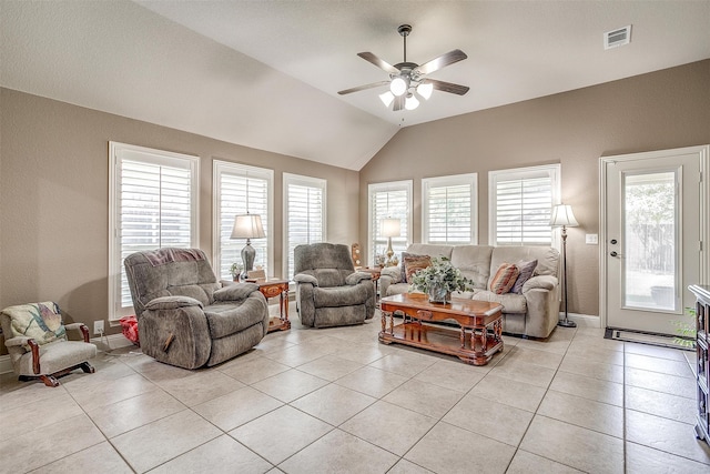 living room featuring ceiling fan, vaulted ceiling, and light tile patterned flooring