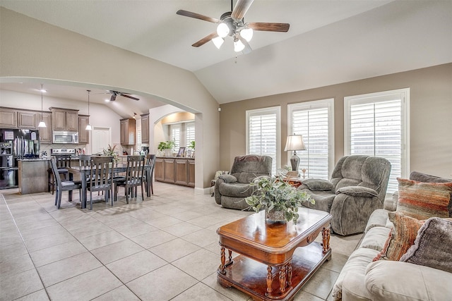 living room featuring ceiling fan, light tile patterned flooring, and vaulted ceiling