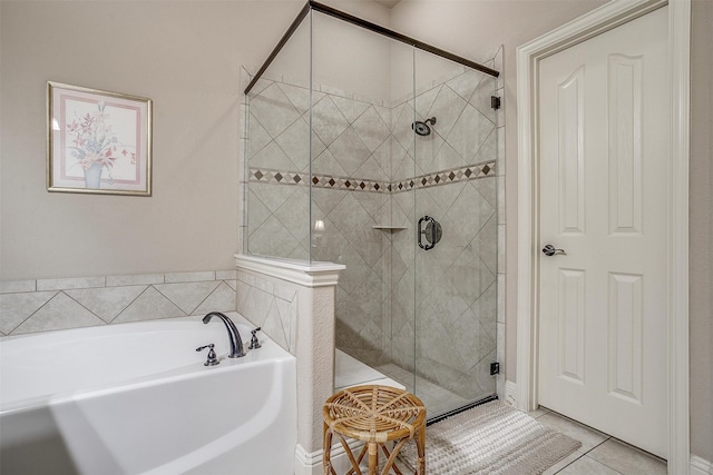 bathroom featuring shower with separate bathtub and tile patterned floors