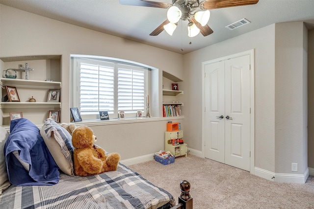 bedroom featuring a closet, ceiling fan, and light colored carpet