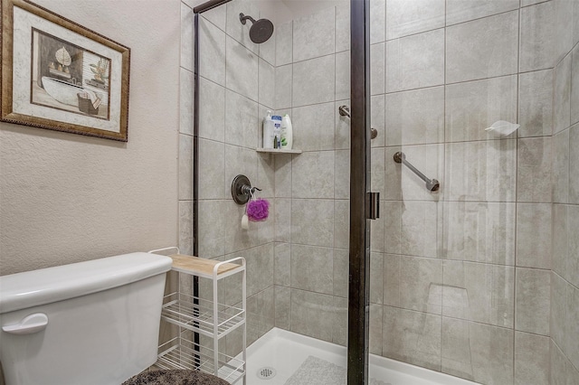 bathroom with toilet and walk in shower