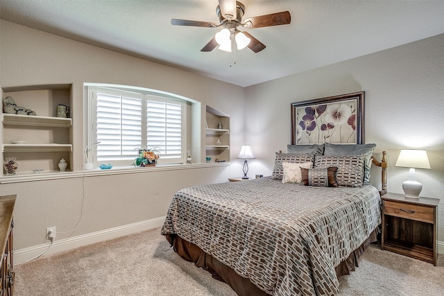 bedroom with ceiling fan and light colored carpet