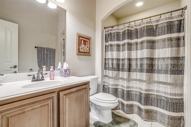 bathroom featuring toilet, tile patterned flooring, and vanity