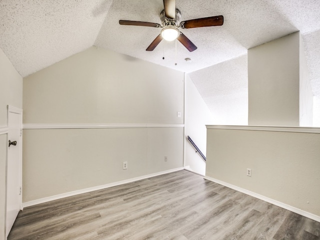 bonus room featuring a textured ceiling, ceiling fan, and hardwood / wood-style floors