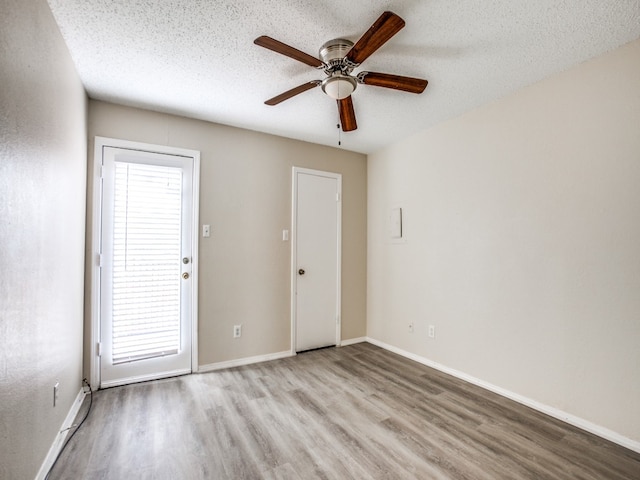 unfurnished room featuring hardwood / wood-style flooring, a textured ceiling, and ceiling fan