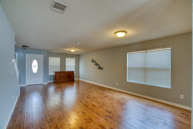 entrance foyer featuring hardwood / wood-style floors and a textured ceiling