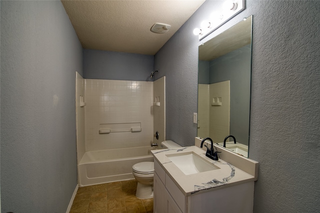 full bathroom with vanity, tile patterned flooring, a textured ceiling, toilet, and tiled shower / bath combo