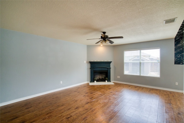 unfurnished living room featuring a textured ceiling, ceiling fan, and hardwood / wood-style flooring