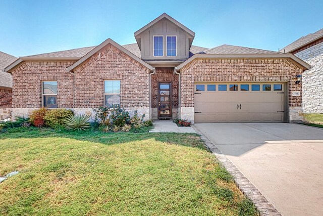 view of front of house with a garage and a front lawn