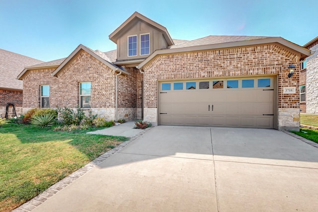 view of front of property with a front yard and a garage