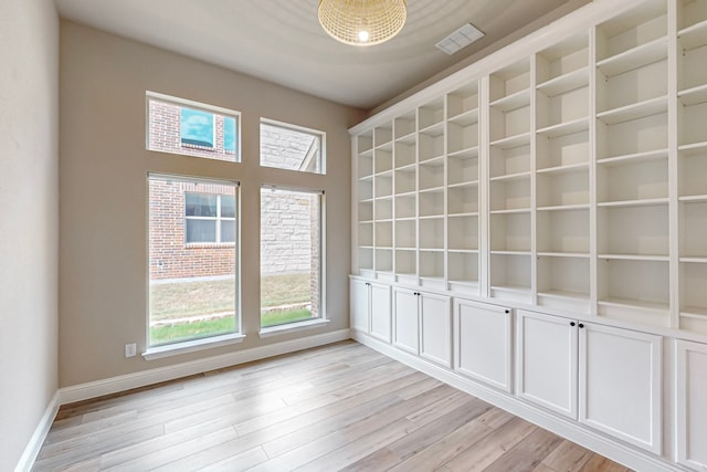 empty room with light hardwood / wood-style flooring