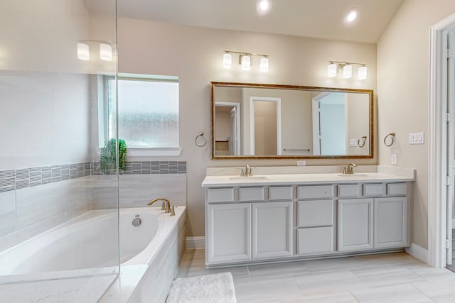 bathroom featuring tiled tub, double vanity, lofted ceiling, and tile patterned floors