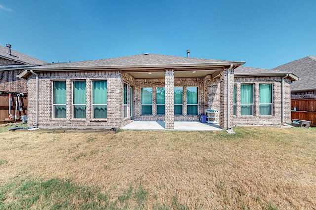 back of property with a patio and a lawn