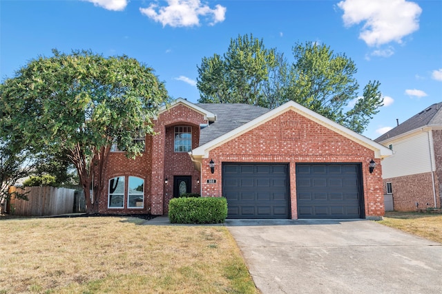 view of front of property with a garage and a front yard