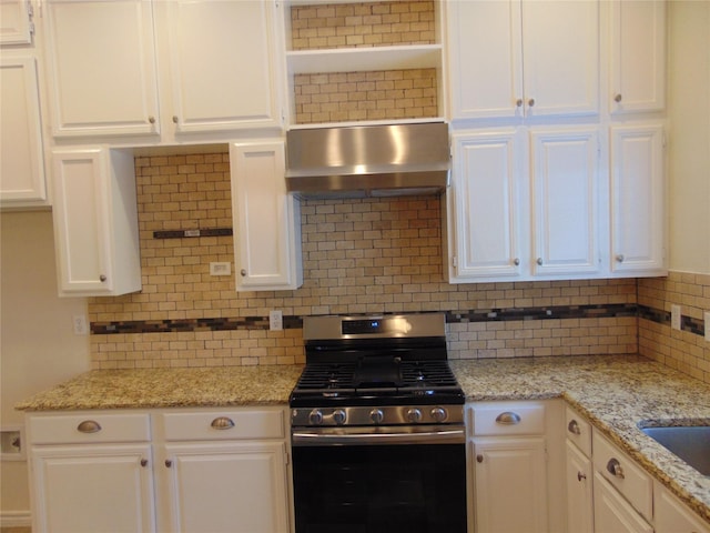 kitchen with white cabinets, ventilation hood, light stone countertops, and stainless steel gas range