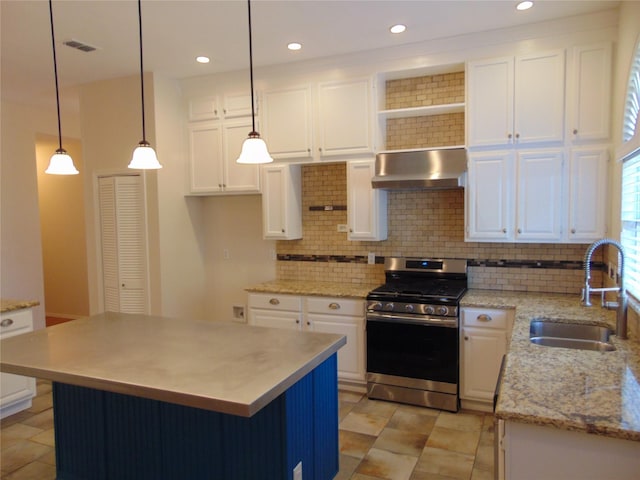 kitchen with hanging light fixtures, white cabinetry, stainless steel range with gas cooktop, and sink