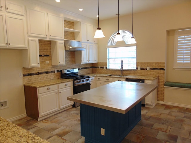 kitchen featuring sink, white cabinetry, hanging light fixtures, a center island, and gas stove