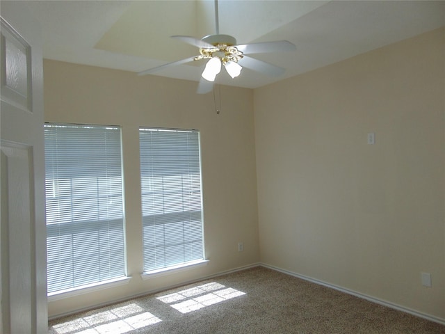 empty room featuring ceiling fan and light carpet