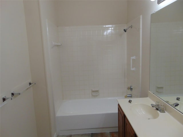 bathroom with vanity and tiled shower / bath combo