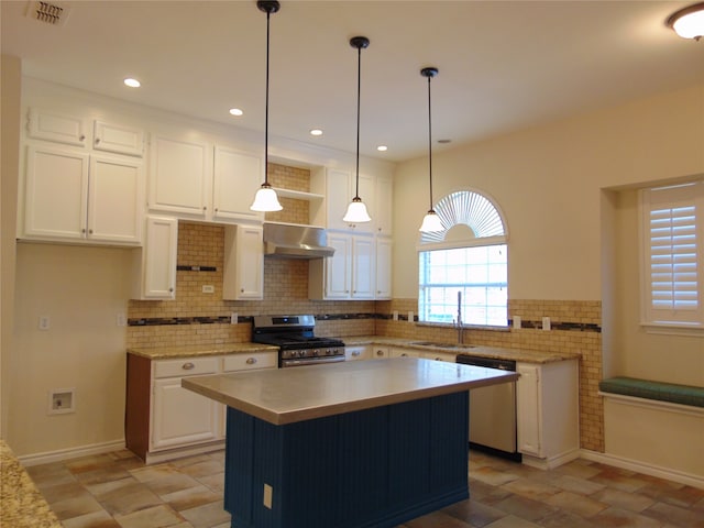 kitchen with wall chimney exhaust hood, white cabinetry, light tile patterned floors, decorative light fixtures, and stainless steel appliances