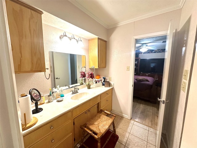 bathroom with tile patterned floors, baseboards, vanity, and ornamental molding