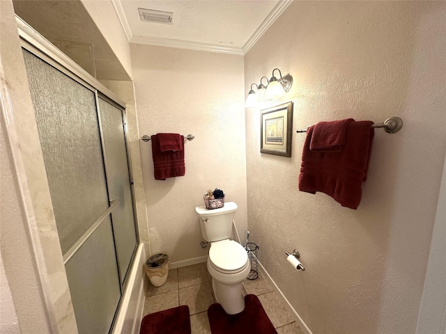 bathroom featuring tile patterned floors, bath / shower combo with glass door, toilet, visible vents, and crown molding