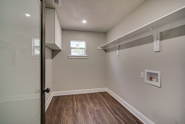 laundry room featuring washer hookup, a textured ceiling, and dark hardwood / wood-style flooring