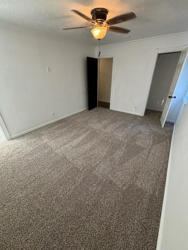 interior space with ceiling fan, carpet, and a textured ceiling