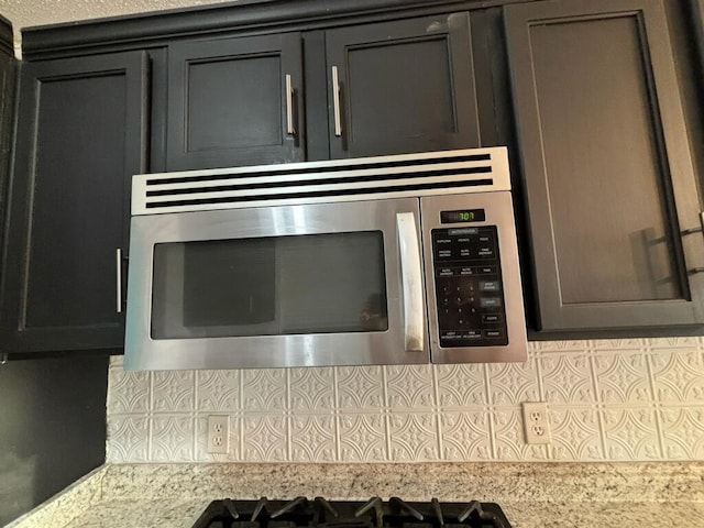 interior details featuring backsplash and light stone counters