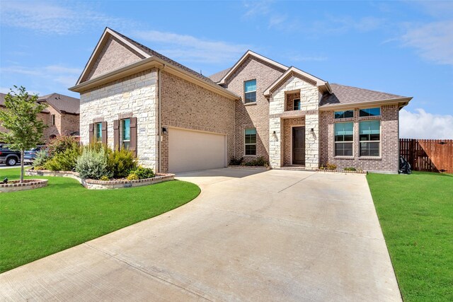 view of front of property with a front yard and a garage