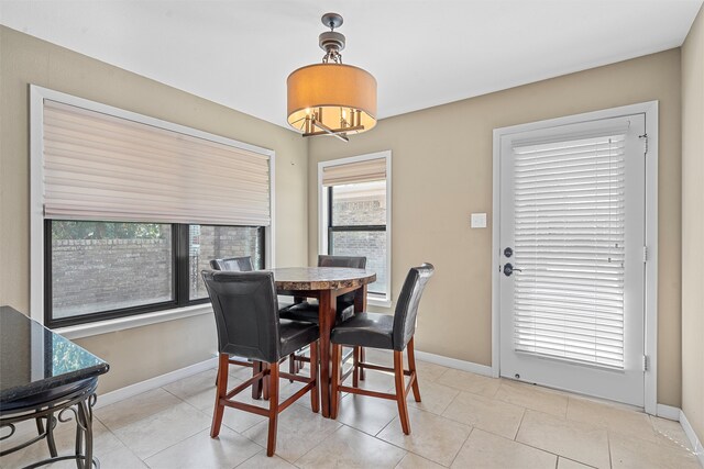 dining space featuring light tile patterned flooring and plenty of natural light