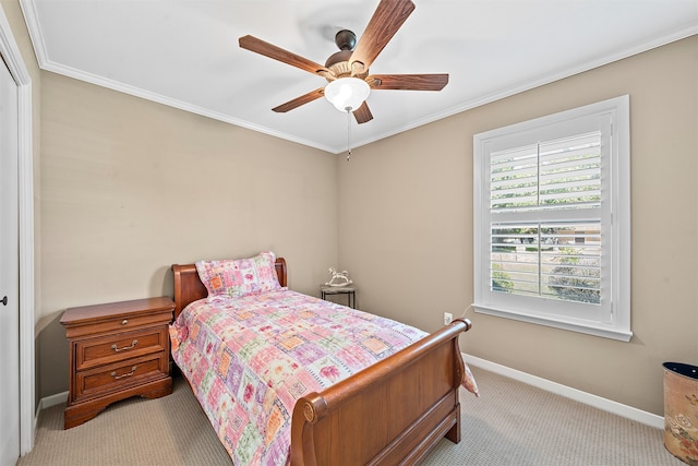 bedroom featuring ceiling fan, ornamental molding, and light colored carpet