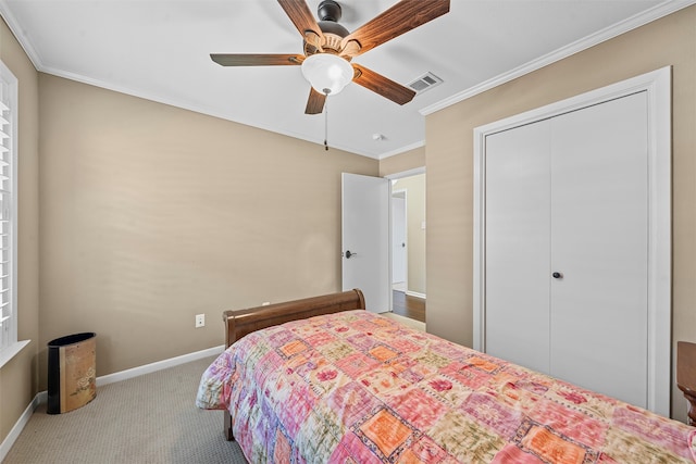 carpeted bedroom with ceiling fan, a closet, and ornamental molding