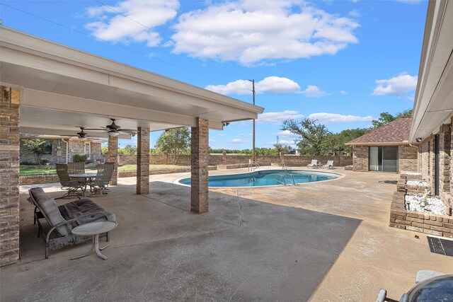 view of pool with ceiling fan and a patio