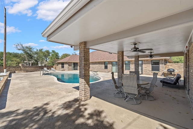 view of swimming pool with ceiling fan and a patio