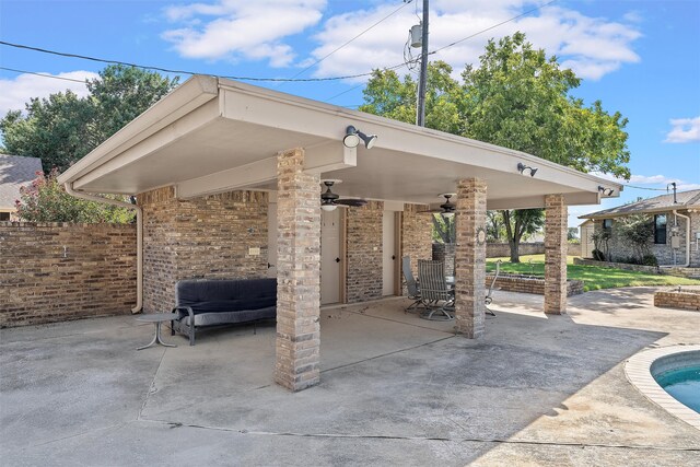 view of patio / terrace featuring ceiling fan and a swimming pool