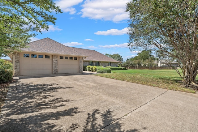 view of front of house featuring a garage and a front yard