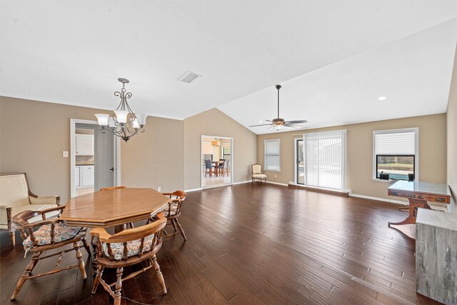 dining room featuring ceiling fan with notable chandelier, vaulted ceiling, and dark wood-type flooring