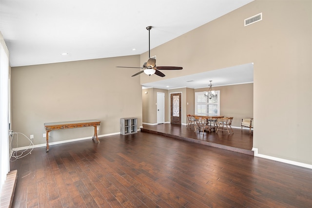 unfurnished living room featuring high vaulted ceiling, ceiling fan with notable chandelier, and dark hardwood / wood-style flooring