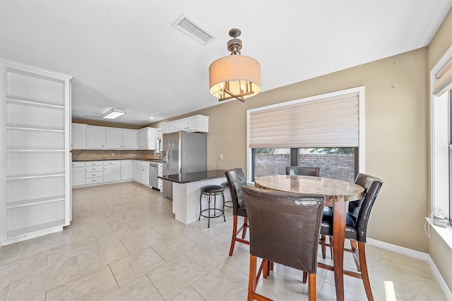 dining space with light tile patterned floors