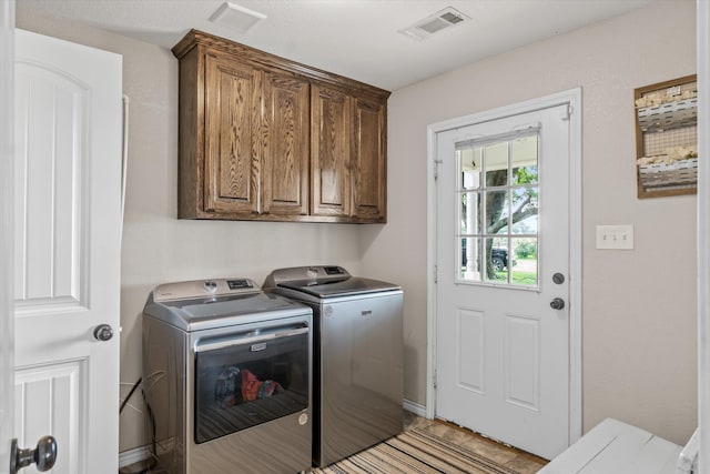 laundry area with cabinets and washer and clothes dryer