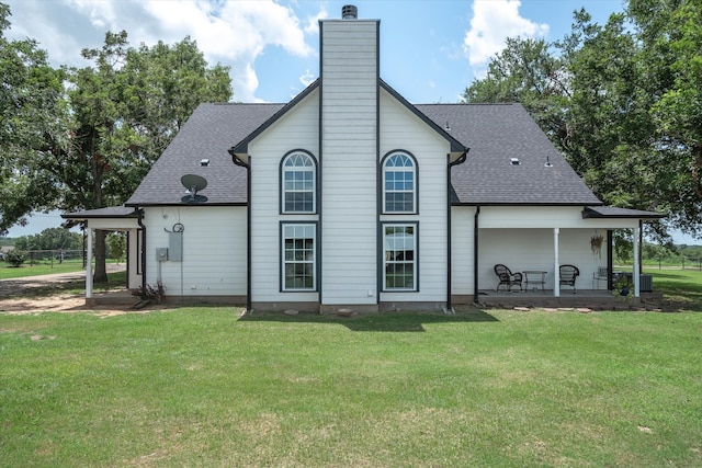 back of house featuring a yard