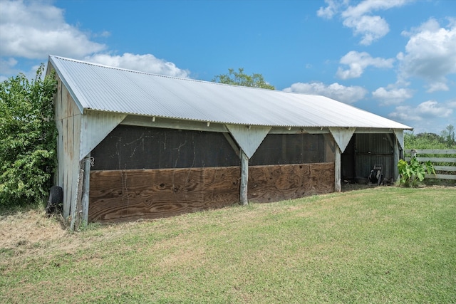 view of horse barn with a yard and an outbuilding