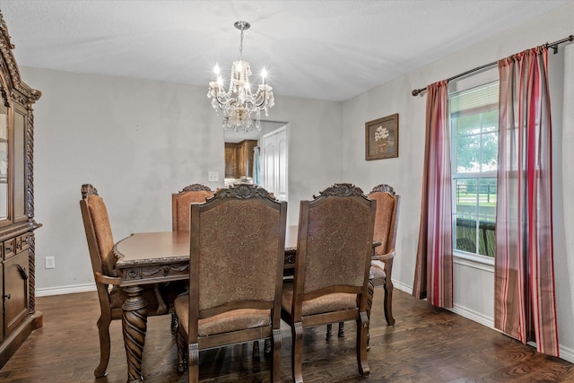 dining area featuring dark wood-type flooring and a notable chandelier