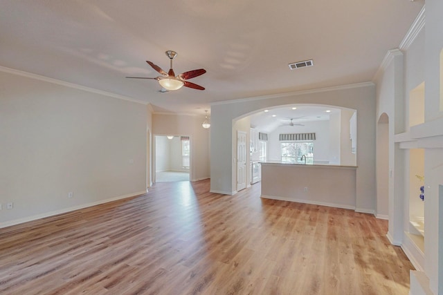 unfurnished living room featuring light hardwood / wood-style flooring, ceiling fan, and crown molding